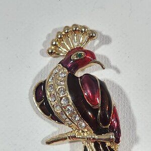 Vintage red enamel peacock brooch with crystal accents.